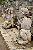 Candi Cetho - Guardians standing on the ninth terrace at the base of the staircase leading to the tenth terrace. 